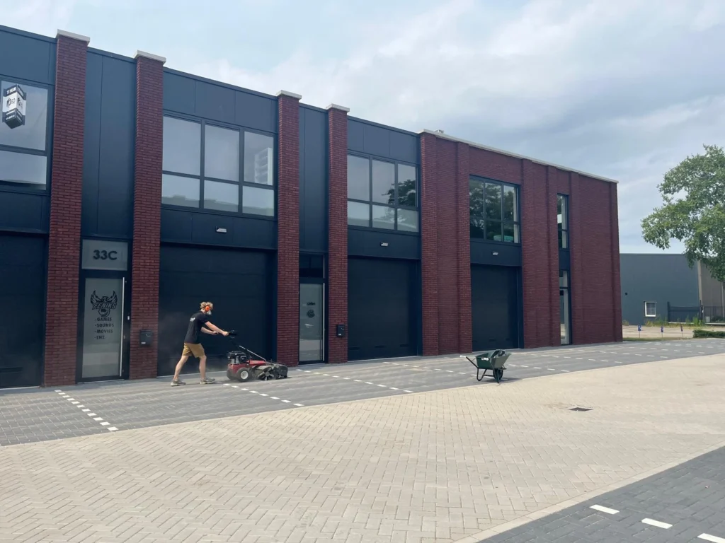 Parkeerplaats vegen met de veegmachine bij de loodsen in Etten-Leur door Burm & Co